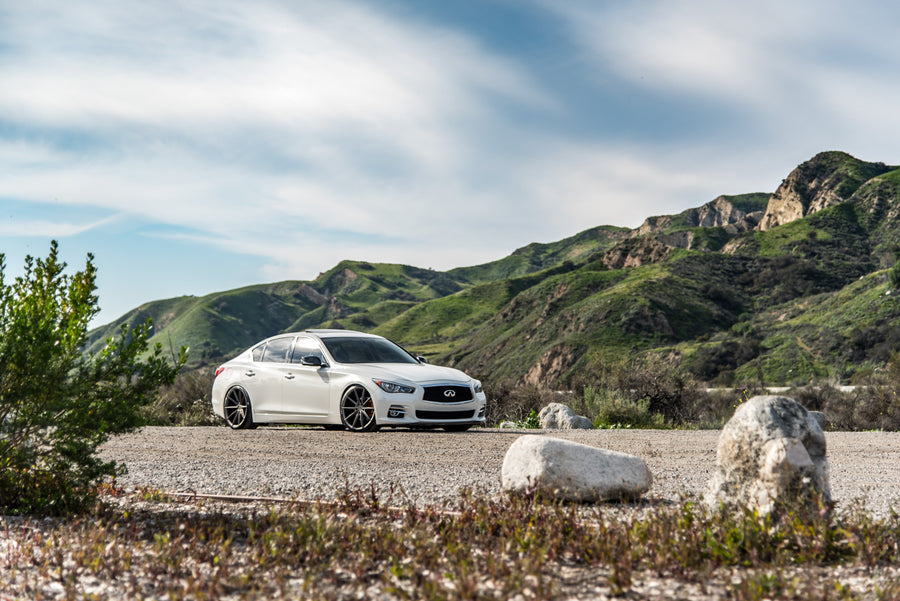 A 2015 Infiniti Q50 on 20 Inch Blaque Diamond BD-11 Matte Antique Bronze Wheels