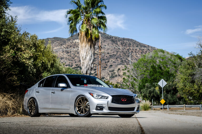 A Silver 2014 Infiniti Q50 on Blaque Diamond BD-23 Bronze Chrome Wheels